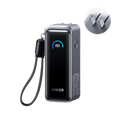 Anker Prime Power Bank 9600mAh with 65W fast charging, dual USB-C ports, smart LCD display, compact design, and included charging cables.