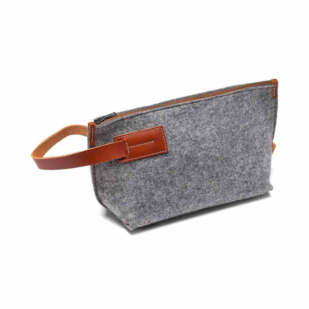 Gray wool felt and vegetable tanned leather travel kit with zipper and spacious compartments for toiletries and essentials