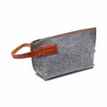 Gray wool felt and vegetable tanned leather travel kit with zipper and spacious compartments for toiletries and essentials