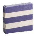 Goats in lavender field near natural handmade soap bars