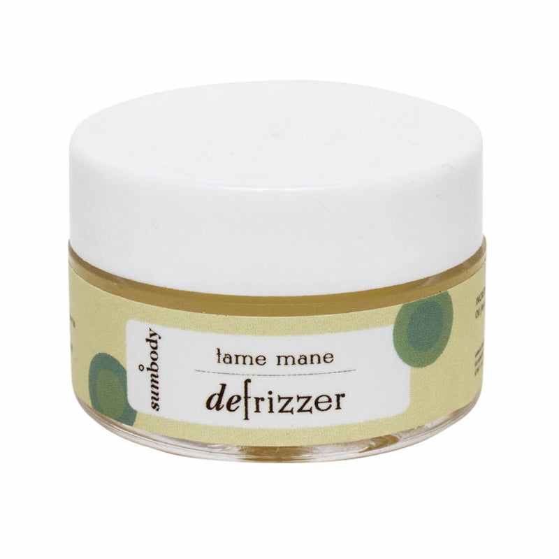 Bottle of Tame Mane De-Frizzer hair oil with natural ingredients for frizz control and shine